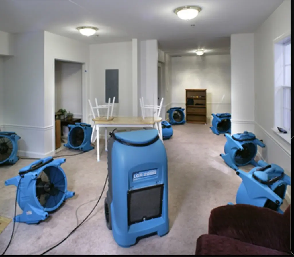 Air movers and dehumidifier setup for Water Damage Restoration in De Witt